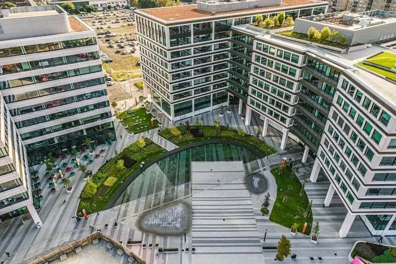 Landscaped courtyard between modern Agora Budapest office buildings